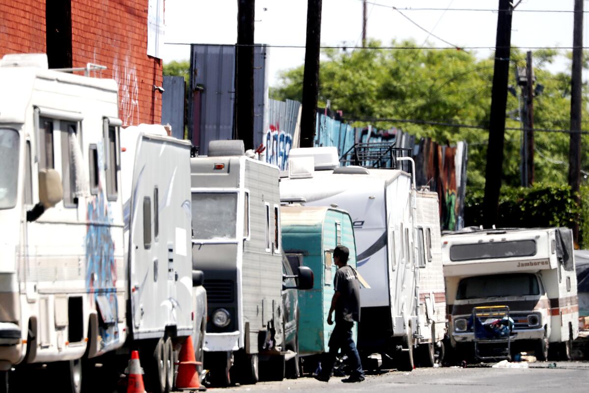  Battered recreational vehicles parked on a street