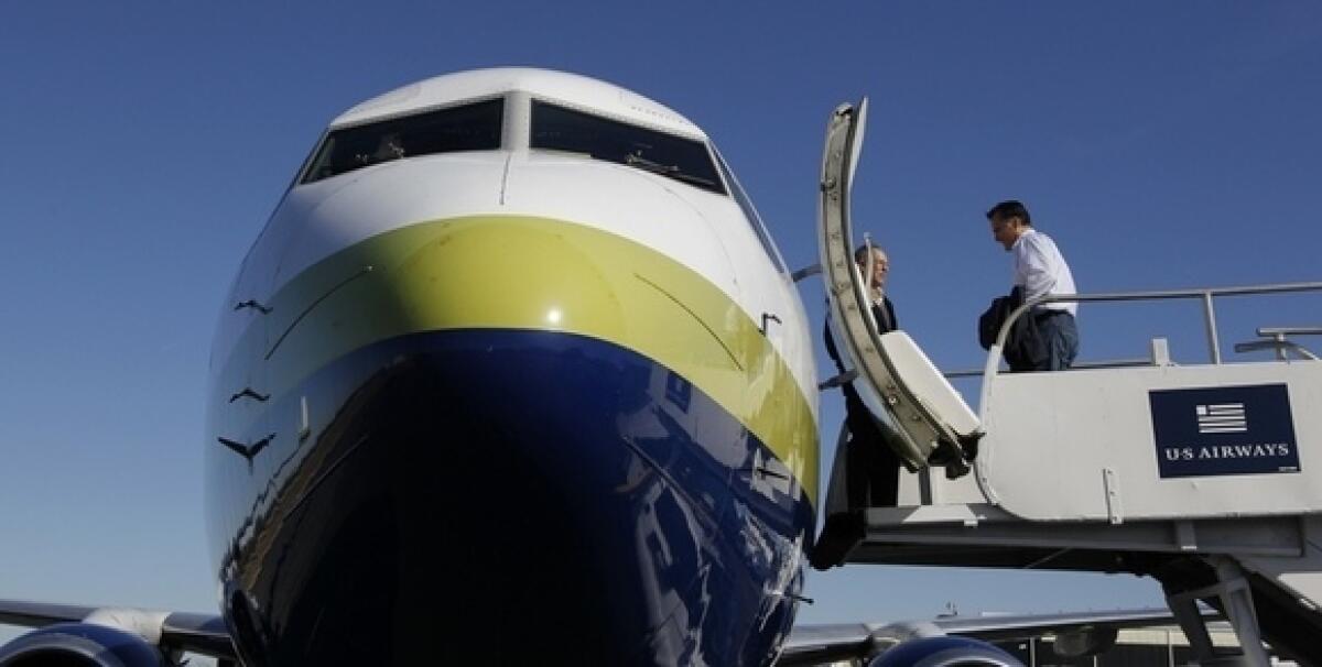 Mitt Romney boards his campaign charter plane in Jacksonville, Fla., on Monday.