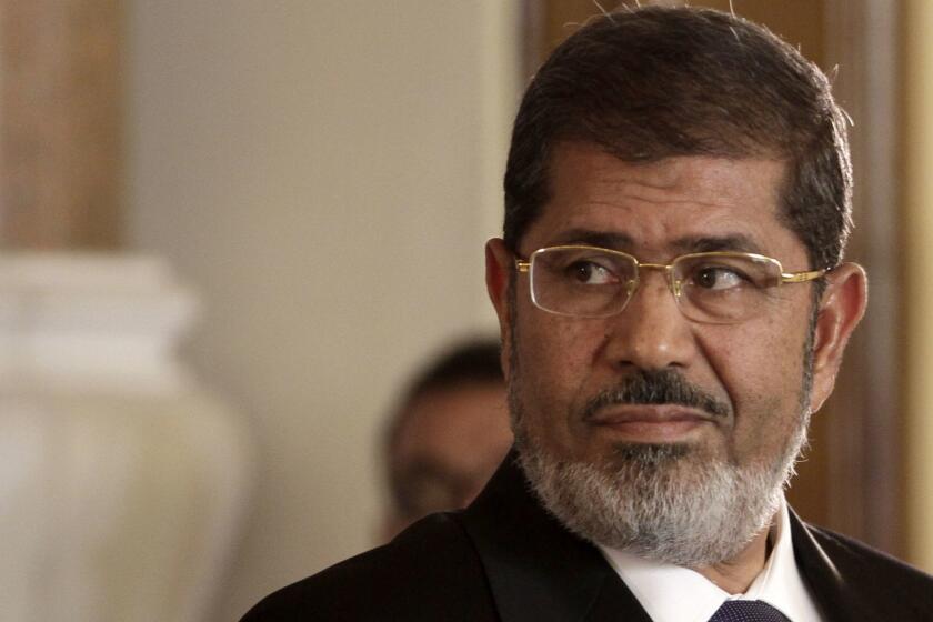 FILE - In this July 13, 2012 photo, Egyptian President Mohammed Morsi holds a news conference with Tunisian President Moncef Marzouki, at the Presidential palace in Cairo, Egypt. On Monday, June 17, 2019, Egypt's state TV said that the country's ousted President Mohammed Morsi has collapsed during a court session and died. (AP Photo/Maya Alleruzzo, File)