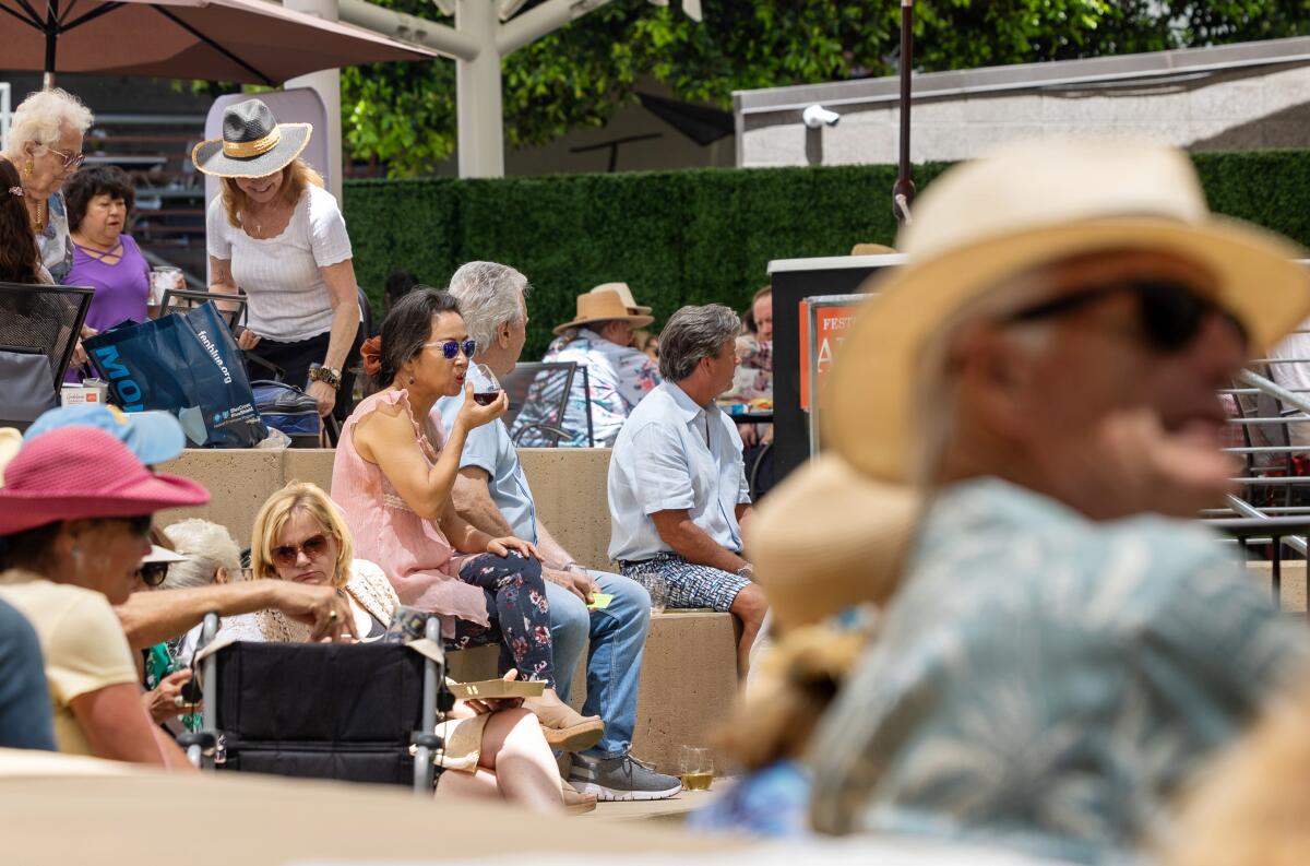 A crowd listens to the Miskey Mountain Boys at the Festival of Arts in Laguna Beach.