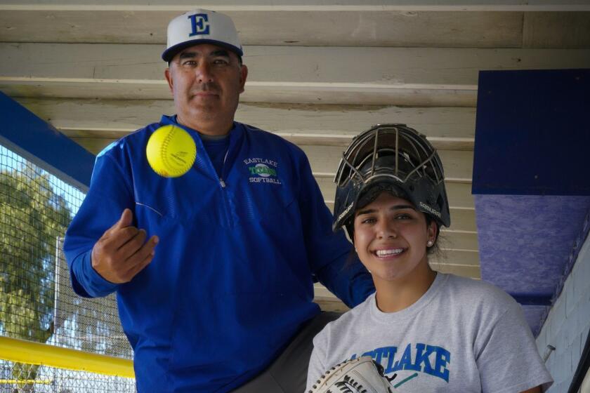 Eastlake High School softball player, Sharlize Palacios who plays catcher for the Titans, along with her dad, Kiko Palacios who is an assistant coach for the Titans. Kiko attended Castle Park High School in Chula Vista and was also a catcher when he played baseball in high school.