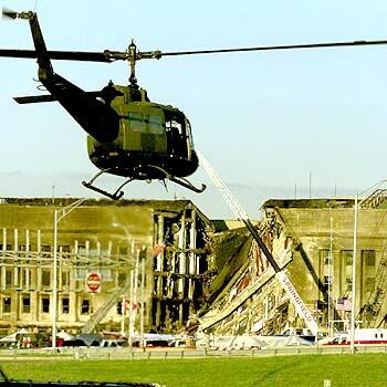 AFTERMATH: A helicopter flies near the Pentagon, where damage from the Sept. 11 strike was being repaired at the time. The attack plan was conceived six years before it was executed.