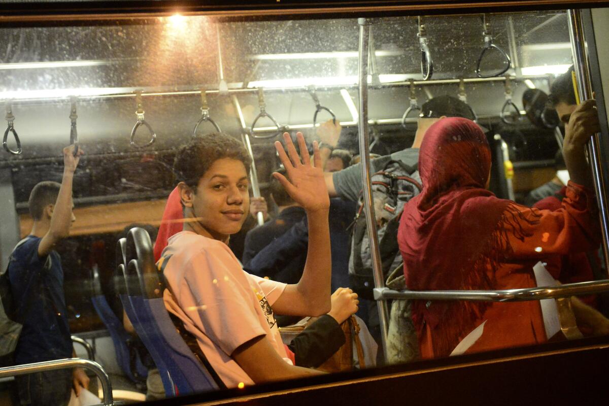 People on a bus waving in Algiers