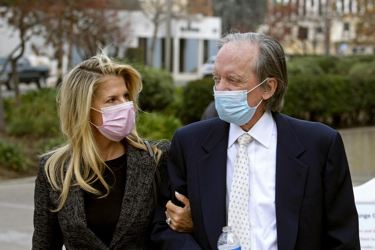 Bill Gross, founder of investment company Pimco, and partner Amy Schwartz arrive for a court hearing.