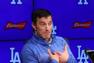 Andrew Friedman answers a question from the media.