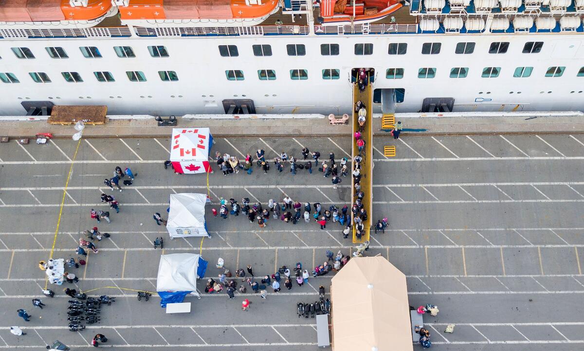 Canadian passengers disembark from the Grand Princess cruise ship at the Port of Oakland