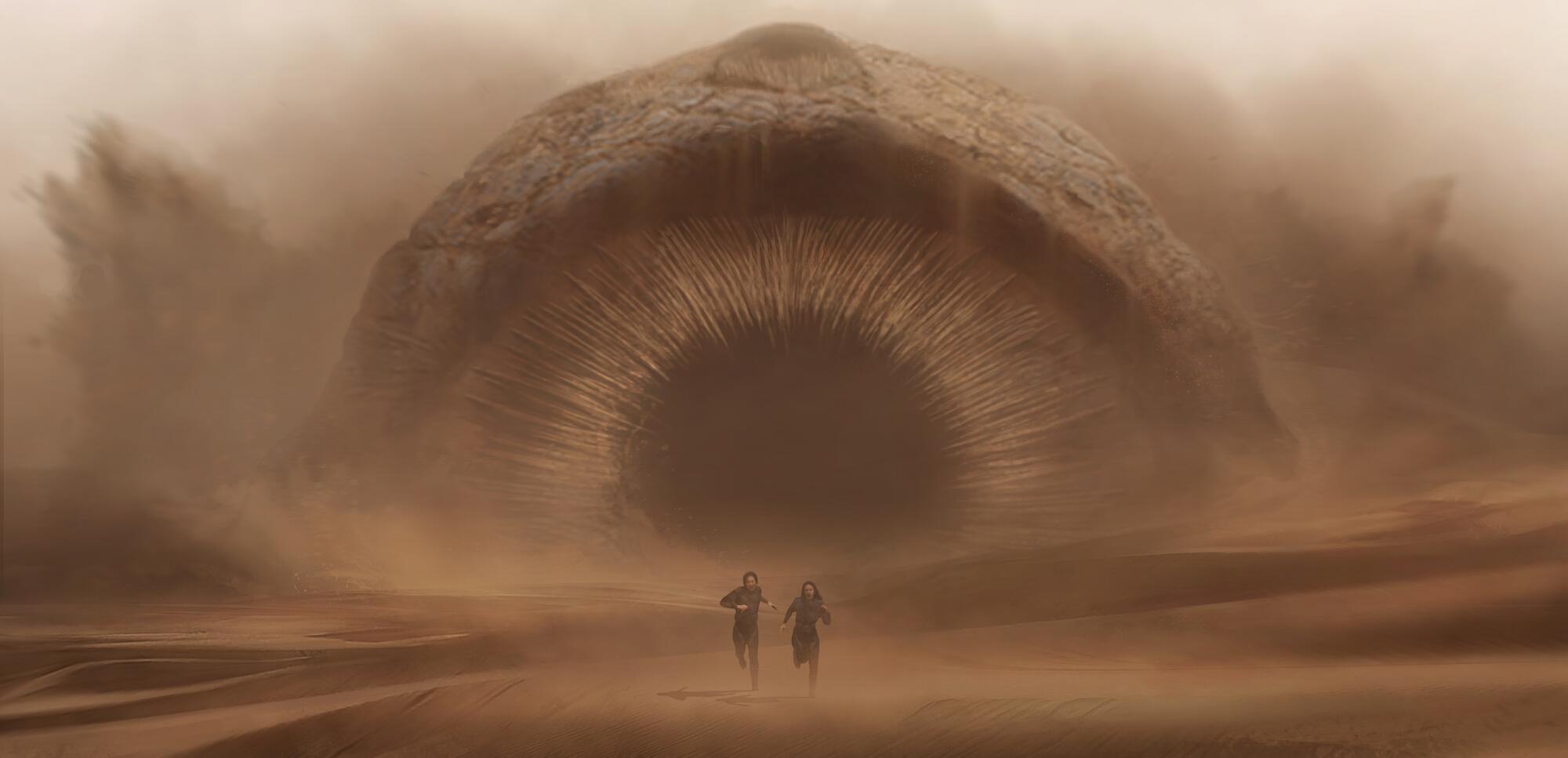 Timothee Chalamet and Rebecca Ferguson flee the gigantic sandworm close behind. 