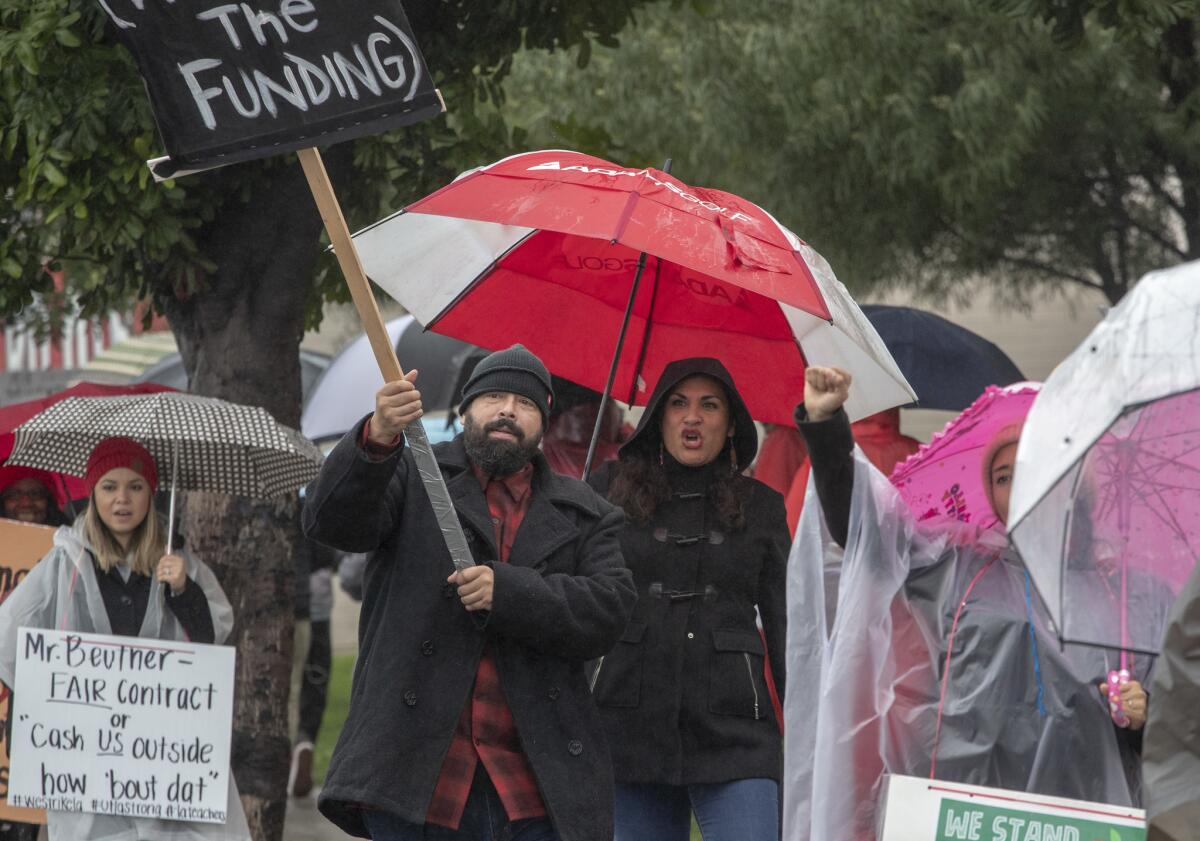 Banning High teacher Arnoldo Vargas on the picket line with his wife, Maricela, outside the campus in Wilmington.