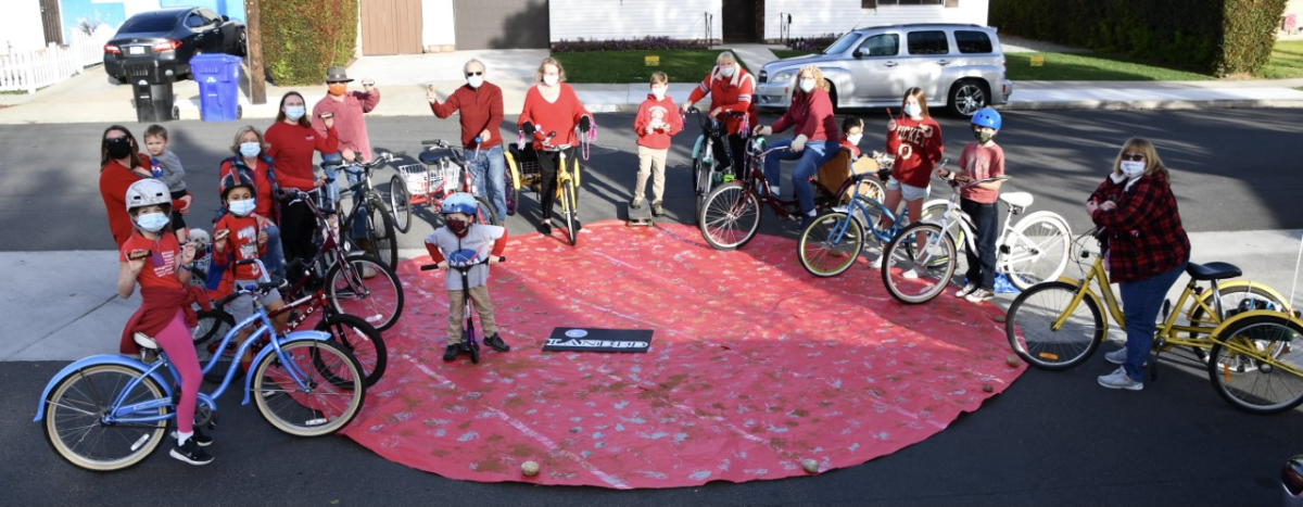 The Clairemont COVID Cruisers pose on a paper planet that Karen Scanlon made to celebrate NASA's Perseverance Mars mission.