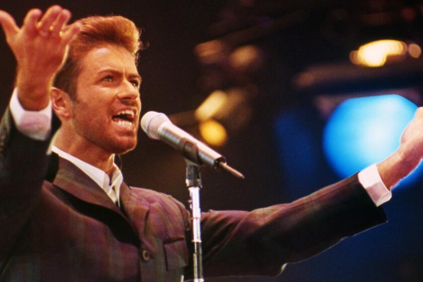 British singer George Michael performs in front of 11,000 people to mark World AIDS Day at London's Wembley Arena in 1993.
