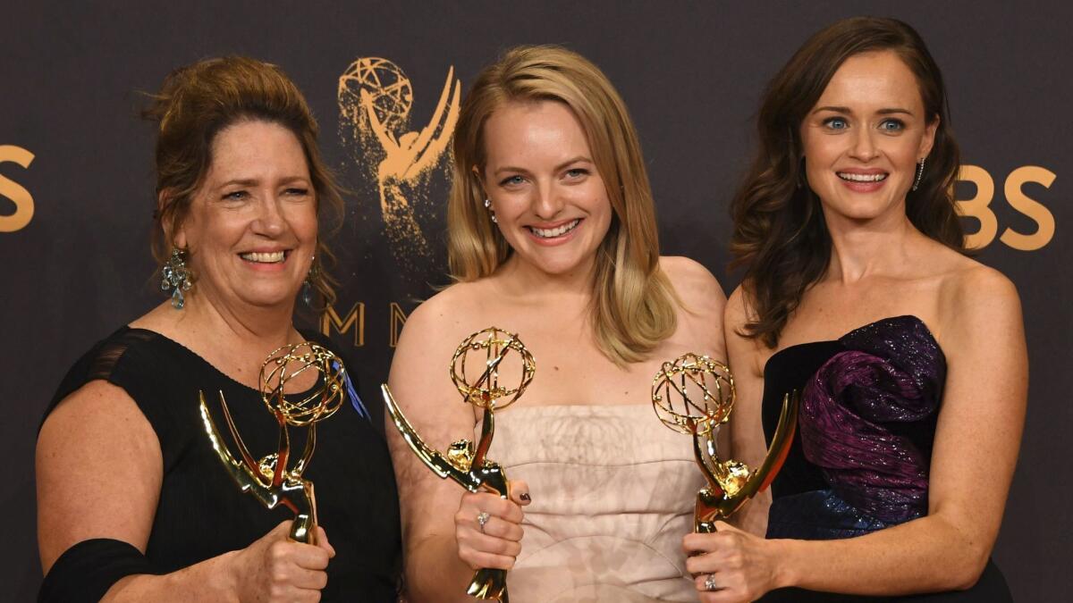 From left: Ann Dowd, Elisabeth Moss and Alexis Bledel pose with the award for drama series for "The Handmaid's Tale" during the 69th Emmy Awards at the Microsoft Theatre on Sept. 17, 2017 in Los Angeles.