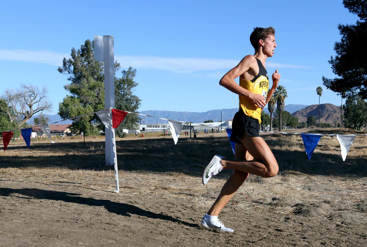 Newbury Park senior Nico Young ran alone most of the race and broke the course record with a time of 13:54:1 at the Southern Section Division 2 cross-country finals last week.