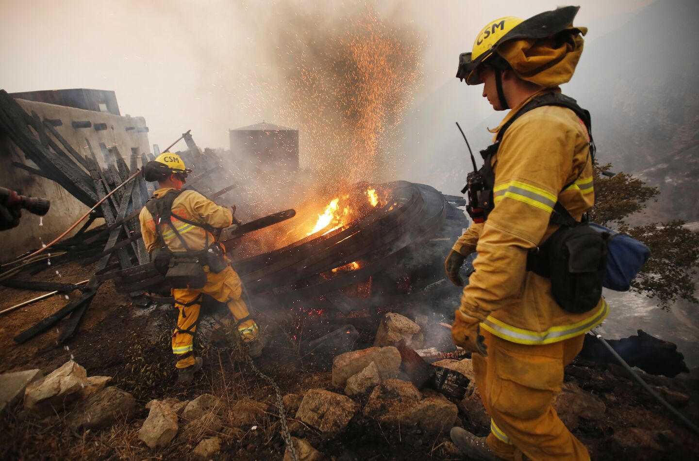 Sacramento firefighters battle a blaze in Toro Canyon in Carpenteria at dusk Tuesday.