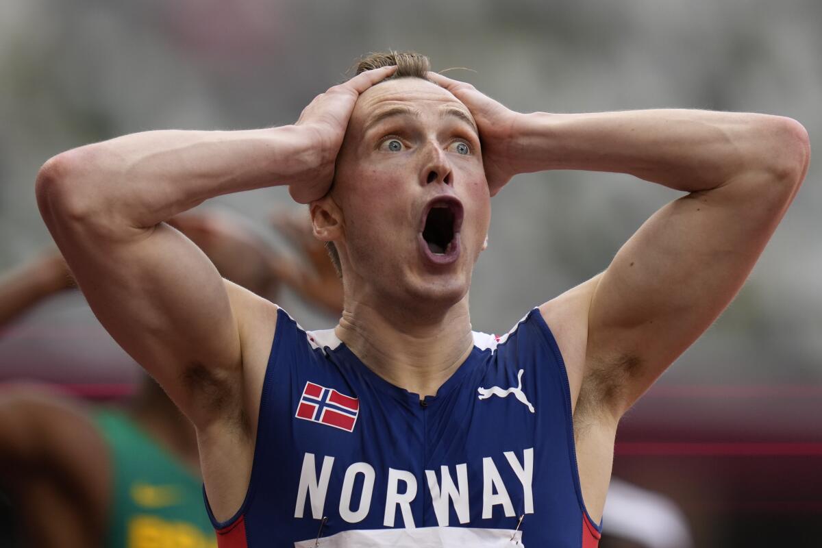 Norway's Karsten Warholm reacts after winning the men's 400-meter hurdles in a world-record time.