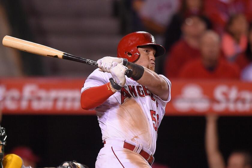 Kole Calhoun hits a solo home run in the eighth inning against the Athletics on Friday to give the Angels a 5-4 win at Angel Stadium.