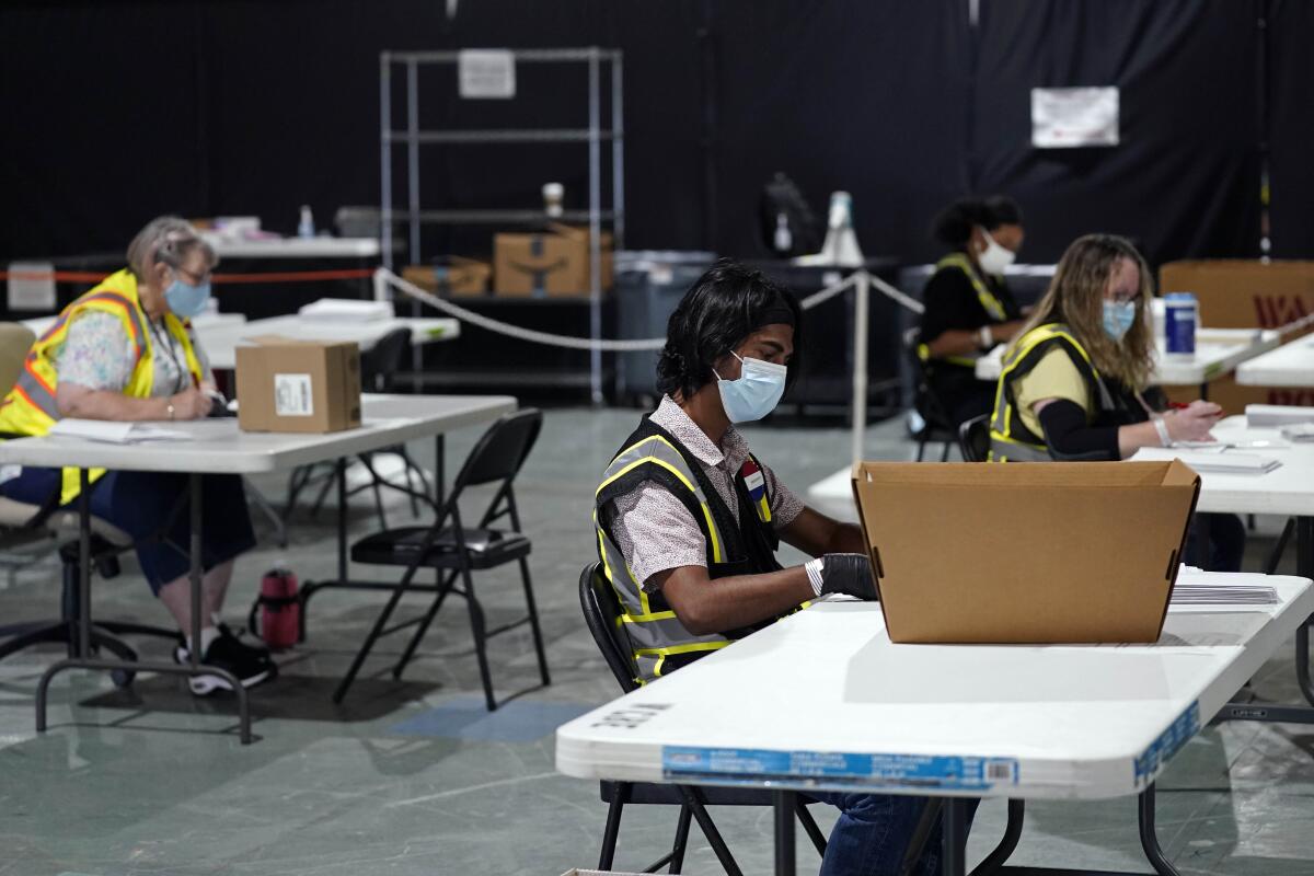 Workers prepare absentee ballots for mailing at the Wake County Board of Elections in Raleigh, N.C.