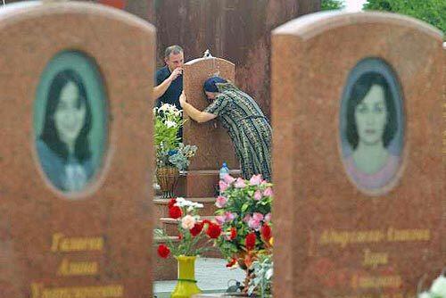 Tears still flow Family members mourn at the grave of Zaur Biziyev, a boy who was only 8 when he died at Middle School No. 1 in Beslan.