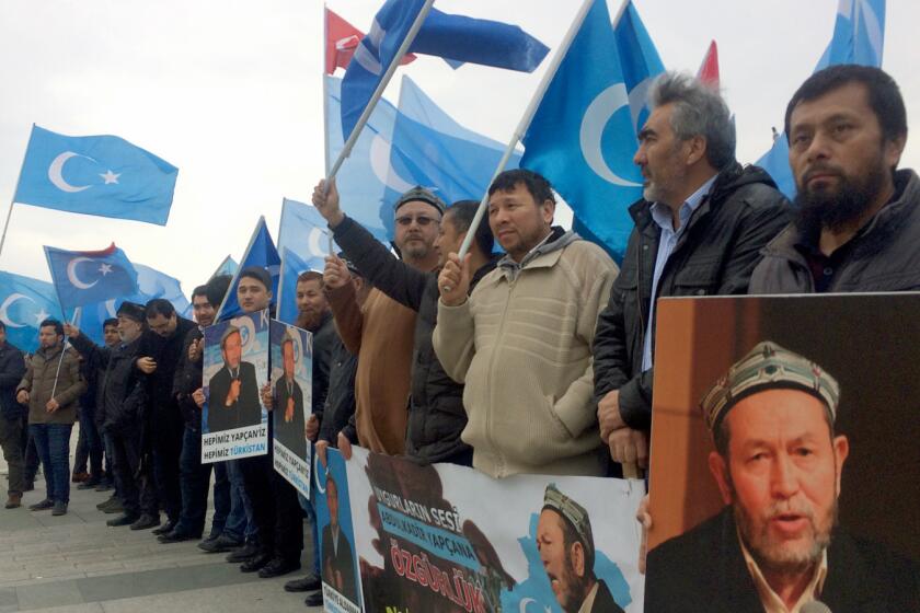 Uighurs protest outside an Istanbul courtroom in support of Abdulkadir Yapcan, who faces extradition to China.