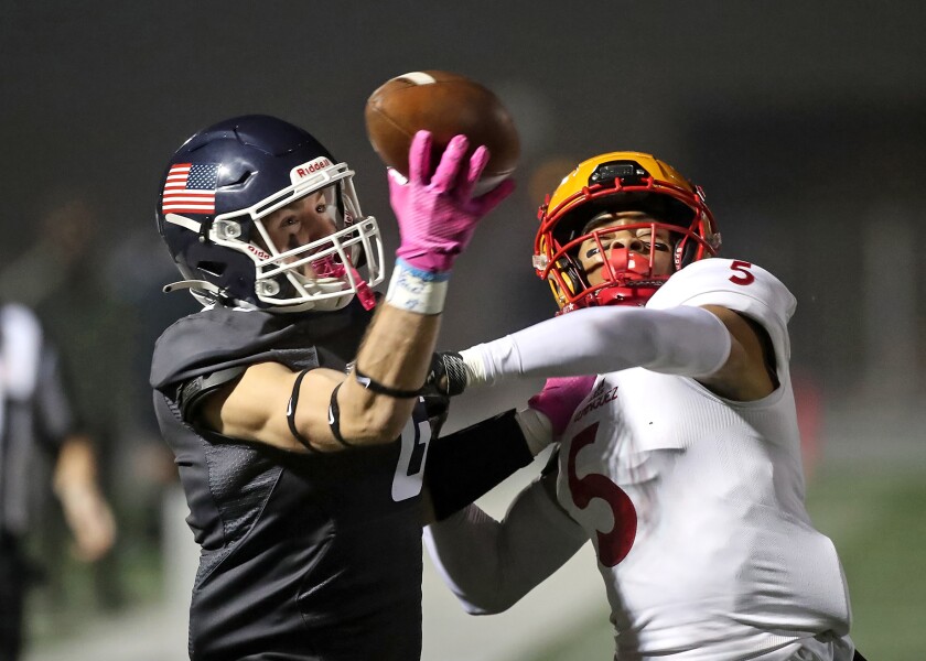 Newport Harbor's Kashton Henjum (6) attempts a catch in the end zone as Dominguez is called for pass interference.