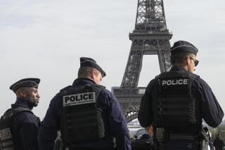 FILE - Police officers patrol the Trocadero plaza near the Eiffel Tower in Paris, Tuesday, Oct. 17, 2023. France's government is threatening prison terms and heavy fines for prank callers making fake bomb alerts, amid a rash of false alarms that forced the evacuation of 15 airports and the cancellation of 130 flights and shut the doors of Versailles Palace for the third time in five days on Wednesday (AP Photo/Michel Euler, File)