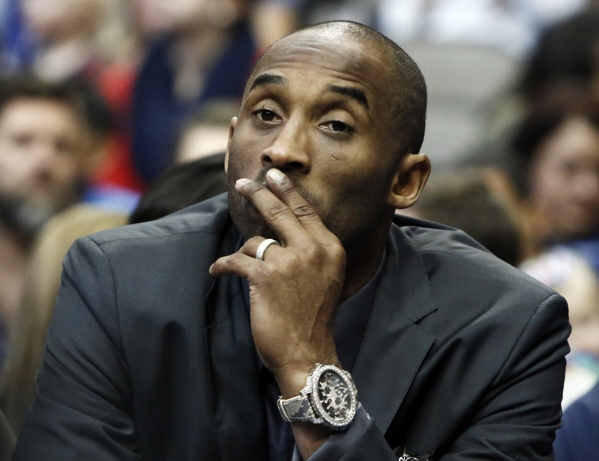 Kobe Bryant looks on from the bench as the Lakers play the Dallas Mavericks on Dec. 26.
