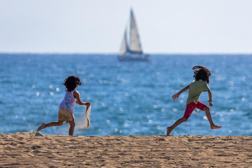 Huntington Beach, CA - August 30: Beach goers kick off the Labor Day weekend amidst warm weather and sunny skies at Bolsa Chica State Beach in Huntington Beach Friday, Aug. 30, 2024. (Allen J. Schaben / Los Angeles Times)