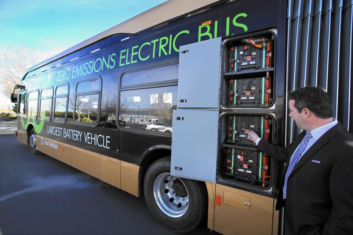 James Holtz, fleet sales manager for BYD Motors Inc., points out some of the battery packs used to power an electric bus built at the firm's Lancaster facility. A state tax credit will enable the company to invest and hire in Greater Los Angeles.