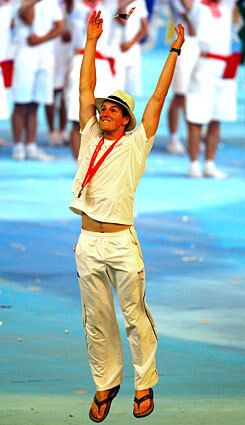 A bronze-medal-winning French athlete romps on to the National Stadium field during the closing ceremony.
