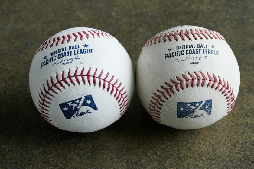 FILE - In this May 7, 2019, file photo, a new official Pacific Coast League baseball, left, is seen beside a baseball from the previous year in Papillion, Neb. Major League Baseball has reorganized its minor leagues in a 120-team regional alignment, MLB announced, Friday, Feb. 12, 2021. The leagues have not yet been named and Major league owners, Commissioner Rob Manfred and his staff have not decided whether to retain the traditional names of the leagues, such as Pacific Coast League. (AP Photo/Nati Harnik, File)
