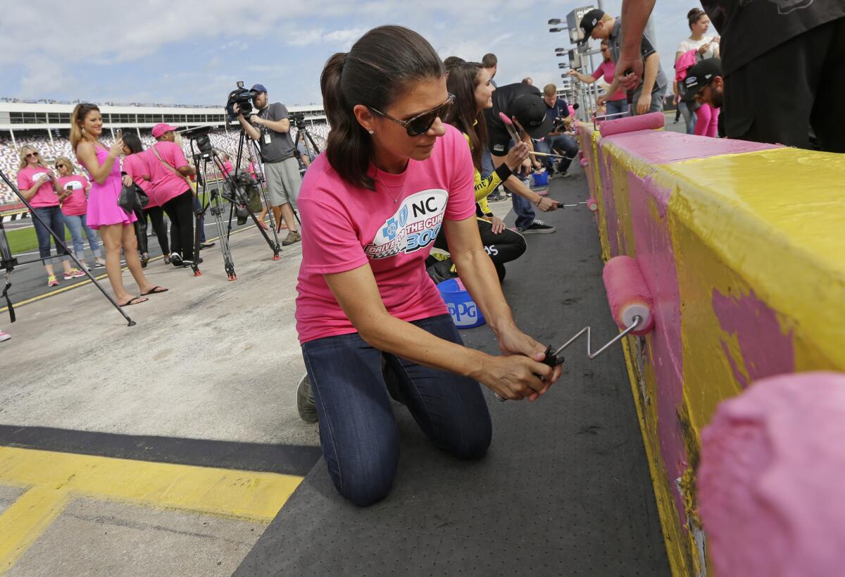 Soccer legend Mia Hamm helps paint the pit road wall pink in honor of breast cancer awareness at Charlotte Motor Speedway on Sept. 30.
