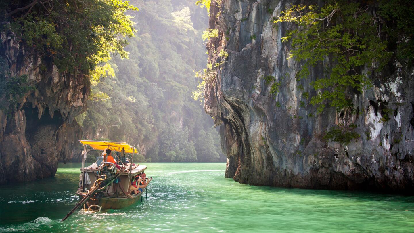 A long-tail boat plies the Andaman Sea off Krabi Province in Thailand.
