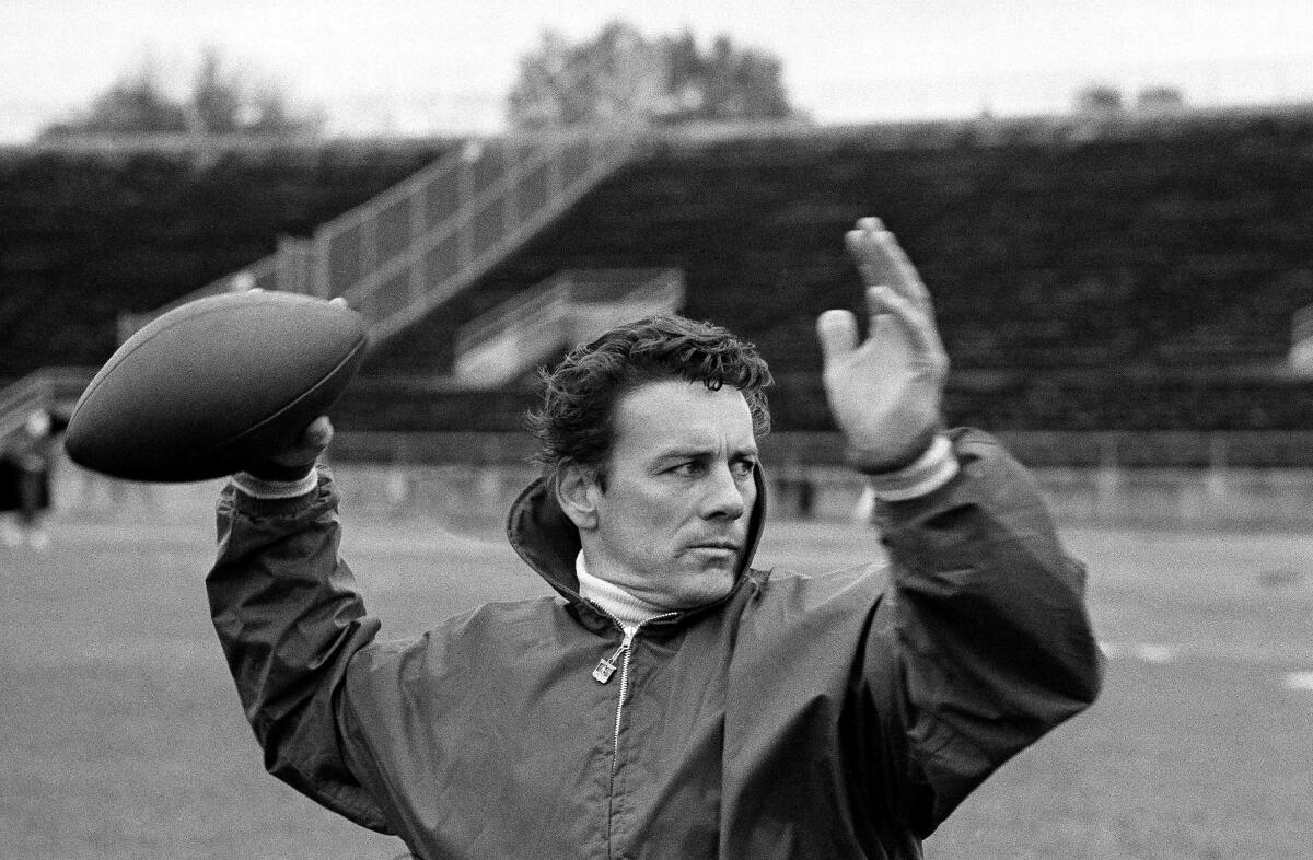 FILE - Len Dawson of the Kansas City Chiefs running through passing drills with receivers in New Orleans to prepare for the Super Bowl, in January 1970. Dawson, the 87-year-old Hall of Fame quarterback who led the Chiefs to their first Super Bowl title, has entered hospice care in Kansas City, Mo. KMBC-TV, the Kansas City station where Dawson began his broadcasting career in 1966, confirmed Dawson is in hospice care through his wife, Linda. (AP Photo, File)