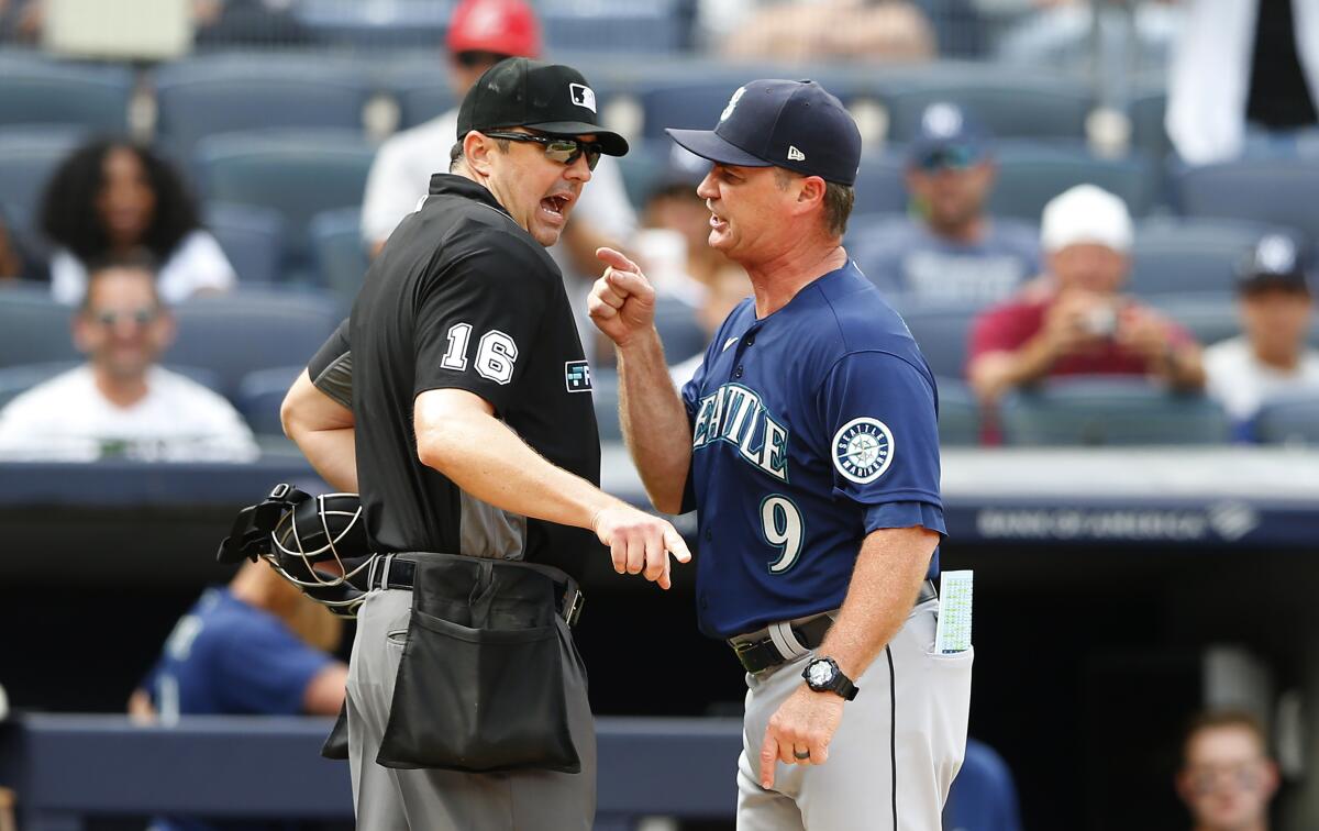 Seattle Mariners manager Scott Servais (9) argues with umpire Lance Barrett (16) before being ejected during the eighth inning of a baseball game against the New York Yankees, Sunday, Aug. 8, 2021, in New York. (AP Photo/Noah K. Murray)