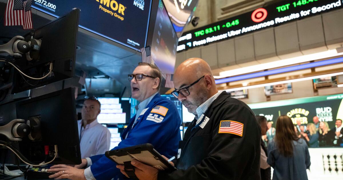 Photo: latimes.com Trader Fred Demarco, right, and Specialist Patrick King, left, work on the floor of the New York Stock Exchange, Wednesday