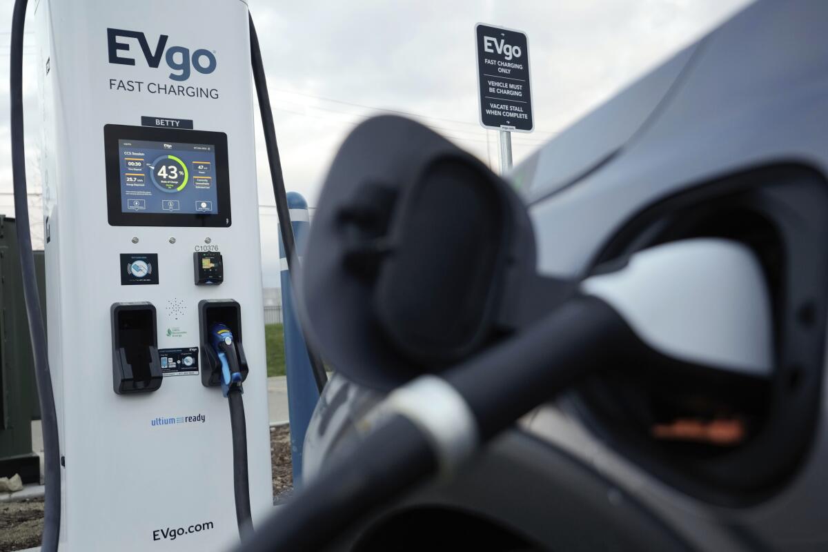 An electric vehicle charges at an EVgo fast-charging station. 