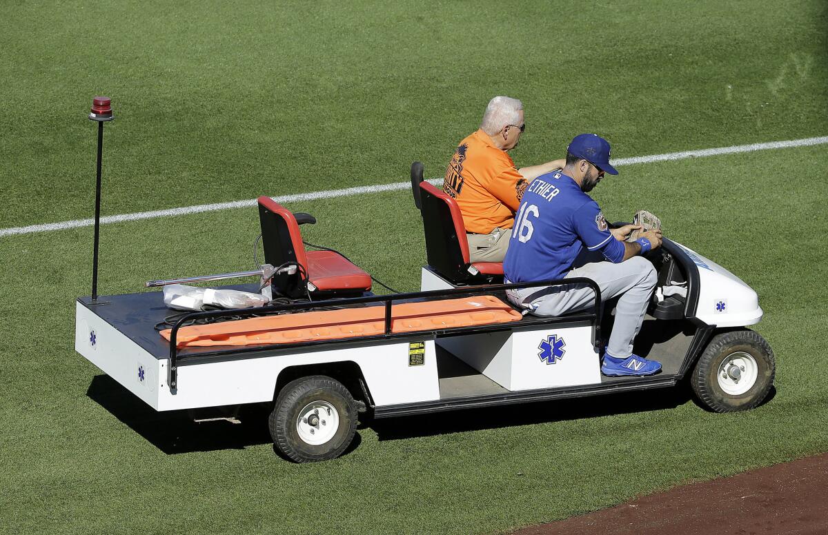 Dodgers right fielder Andre Ethier (16) is carted off the field after fouling a ball off his shin during a spring training game on March 18.