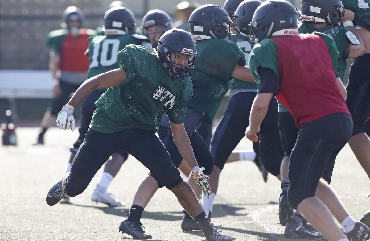 Sage Hill School defensive end Alvaro Corona, left, shown in practice on Aug. 28, helped the Lightning win 54-0 at Lucerne Valley on Saturday night.
