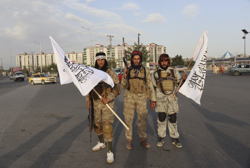 Taliban fighters holding Taliban flags in Kabul, Afghanistan