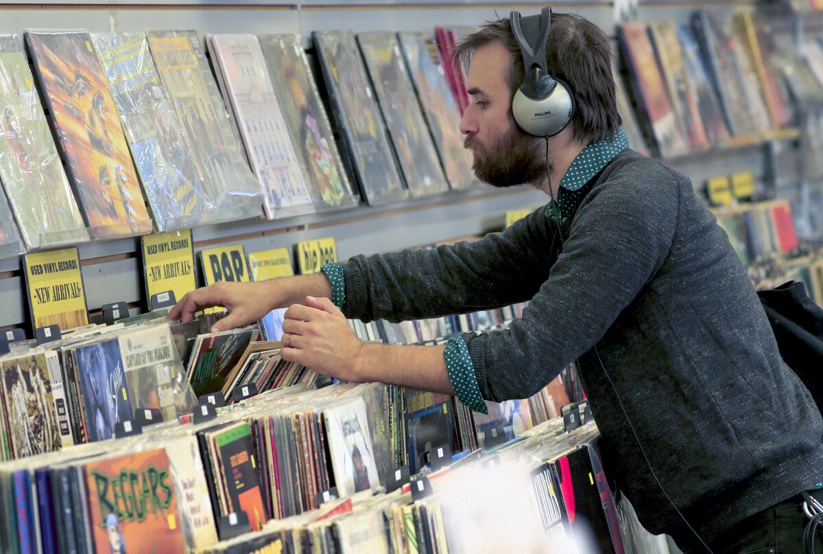 A customer listens to musicat Rhino Records in Claremont Village September 29, 2019. 