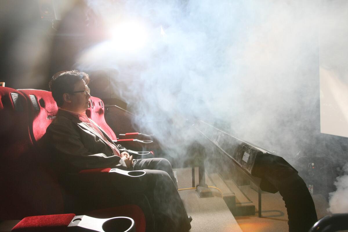 Theodore Kim, chief operating officer, LA LAB of CJ 4DPLEX, is photographed in Hollywood on June 7, 2012. He is surrounded by fog, one of many effects created by the companies 4DX system.