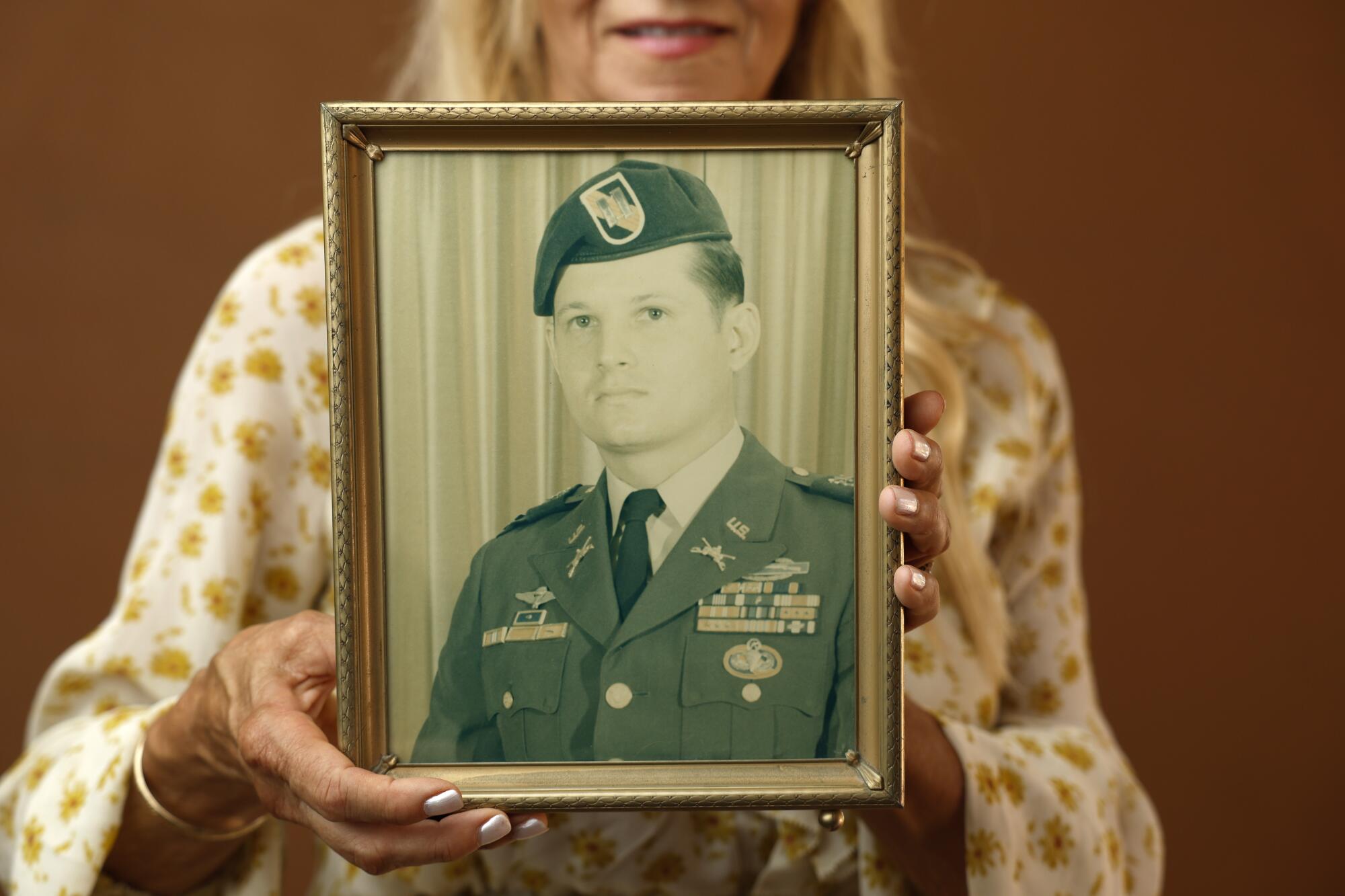 Kathy Ferrari holds a picture of her brother Jimmy Lewis, a CIA officer killed in the 1983 Beirut embassy bombing