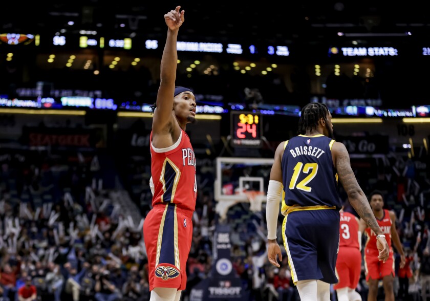 New Orleans Pelicans guard Devonte' Graham (4) reacts after scoring a three-point basket against Indiana Pacers forward Oshae Brissett (12) in the fourth quarter of an NBA basketball game in New Orleans, Monday, Jan. 24, 2022. (AP Photo/Derick Hingle)
