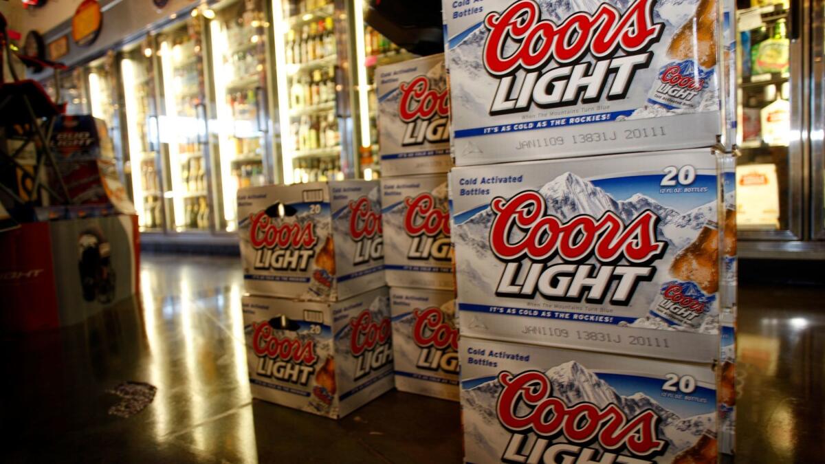 Packages of Coors Light on display in front of coolers in a liquor store in Denver. Sales of Coors Light cases fell 3.4% year-to-date through Sept. 30.
