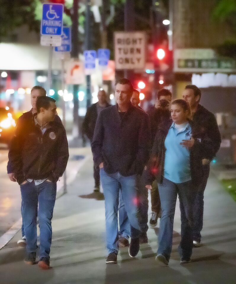 California Governor Gavin Newsom (D), center, along with others, walk the downtown San Diego streets before dawn, during the annual point-in-time homeless count, January 23, 2020.