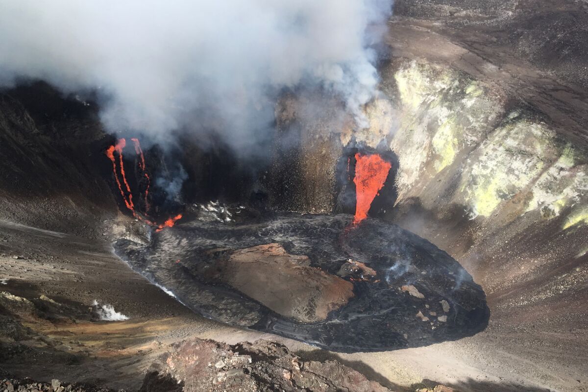 Plumes of gas and smoke rise near active fissures in the crater of Hawaii's Kilauea volcano Monday.