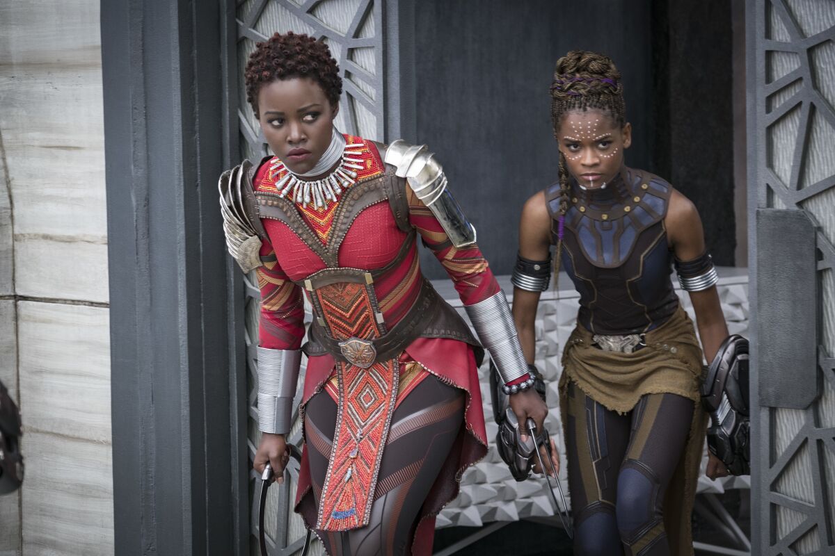 This image released by Disney shows Lupita Nyong'o, left, and Letitia Wright in a scene from Marvel Studios' "Black Panther." The Walt Disney Co. is pushing back the release dates of many of its upcoming titles, including the Black Panther sequel “Wakanda Forever,” which is currently in production. (Matt Kennedy/Marvel Studios-Disney via AP)