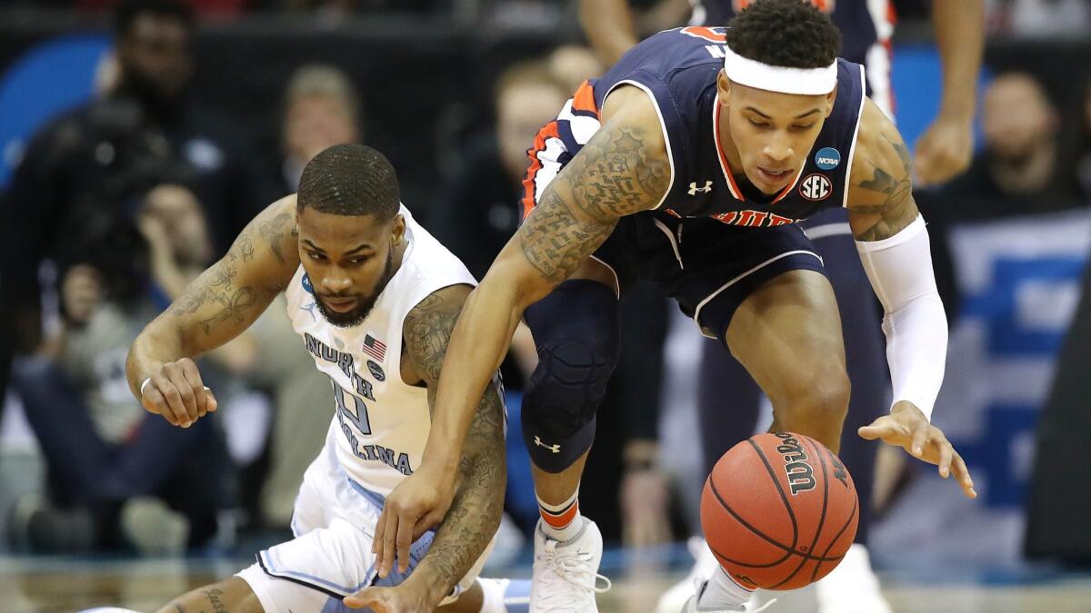 North Carolina's Seventh Woods (0) battles for a loose ball with Auburn's Bryce Brown (2) during the 2019 NCAA tournament Midwest Regional on Friday in Kansas City, Mo.