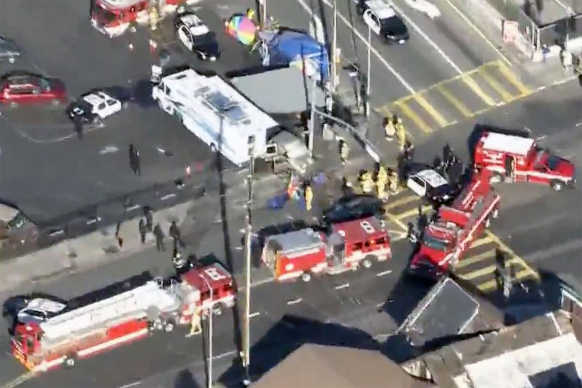 Aerial view of police cars, firetrucks and ambulances surrounding a crash scene at an intersection
