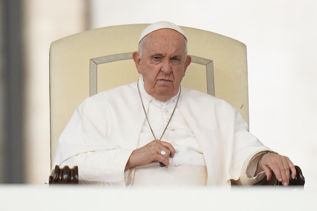 Pope Francis listens during his weekly audience.