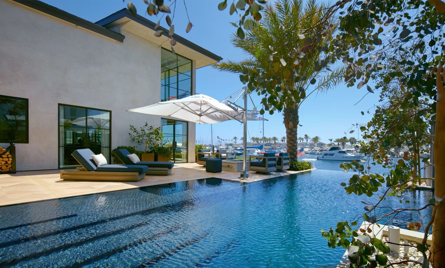 The waterfront home claims three lots and opens to 105 feet of harbor frontage.